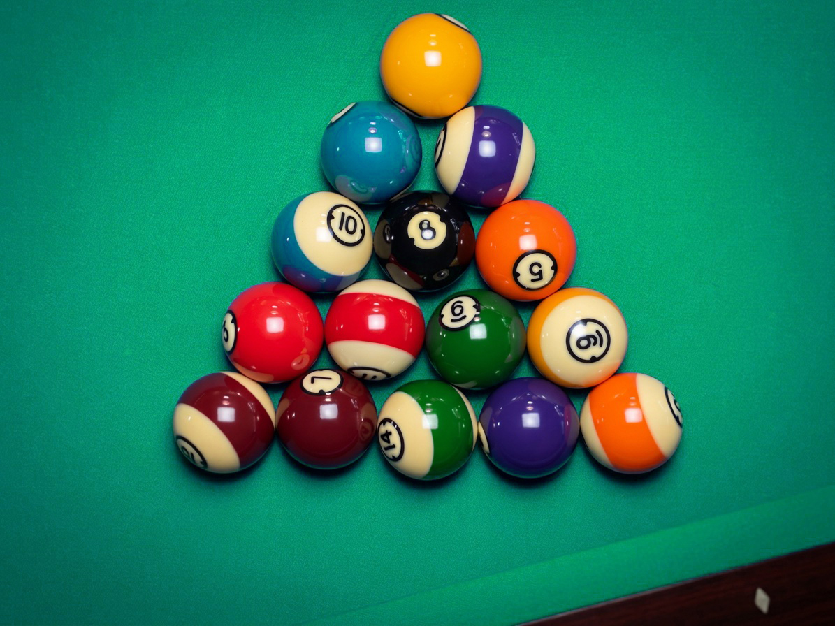 Racked triangle of balls seen from above on blue cloth